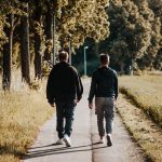 Friends Walking Together Outdoors on Footpath