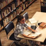 Young female student study in the library using laptop for resea